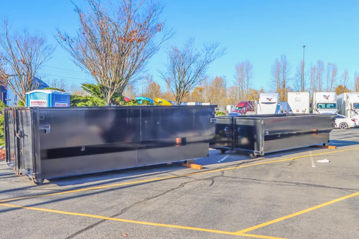 Professional dumpster rental service with roll-off container on residential driveway in East Stroudsburg